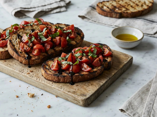 Tomato bruschetta on grilled sourdough with basil and aged balsamic