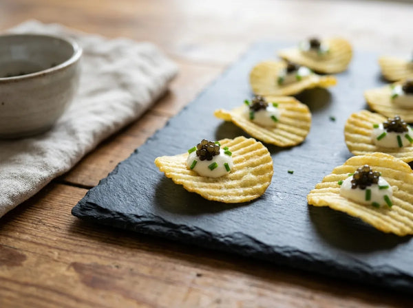 Ridged potato crisps topped with creme fraiche and caviar
